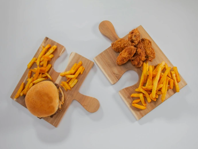 a couple of wooden cutting boards topped with french fries